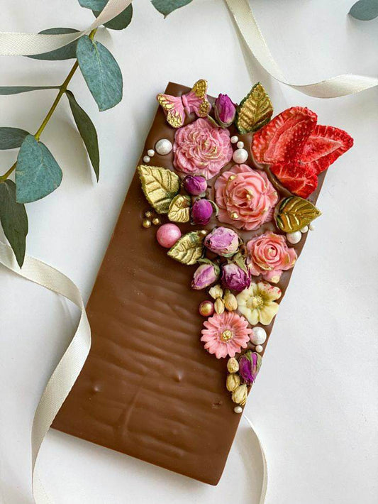 Milk chocolate bar with dried roses and chocolate flowers