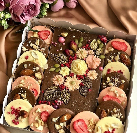 Milk chocolate bar with chocolate flowers and mendicant with nuts and dried fruits